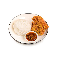Delicious fried chicken with crispy skin, chillis sauce and rice on bowl