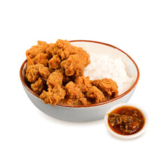 Delicious fried chicken with crispy skin, chilli sauce and rice on bowl