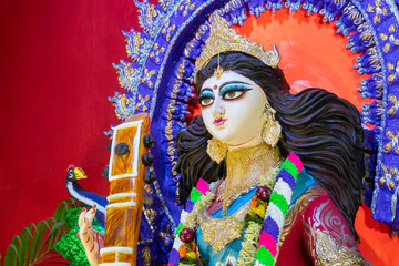 Fototapeta na wymiar Face of Goddess Saraswati at Kolkata, West Bengal, India. Saraswati is Hindu goddess of knowledge, music, art, wisdom, and learning. Worshipping is done to get divine blessing to achieve excellence.