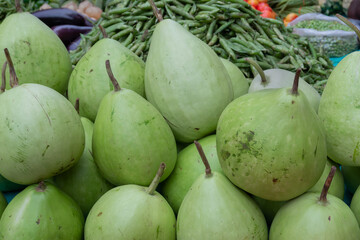 Calabash, bottle gourd, or white-flowered gourd, Lagenaria siceraria, is a vine grown for its fruit. Vegetables for sale in a market in Territy Bazar, Kolkata, West Bengal, India.