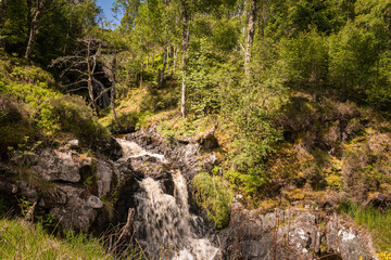 A bright, summer HDR image of Allt na h-annaite, a waterfall along Strathconon in Ross-shire,...