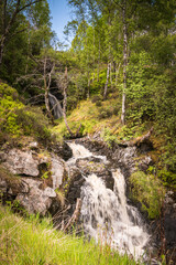 A bright, summer HDR image of Allt na h-annaite, a waterfall along Strathconon in Ross-shire, Scotland