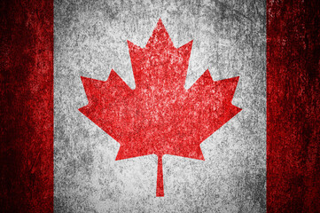 Fototapeta premium Closeup of grunge Canadian flag. Dirty Canada flag on a metal surface