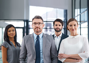 We are the benchmark. Cropped portrait of a group of businesspeople standing in the office.