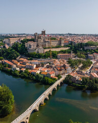 Fototapeta na wymiar Aerial view of Pont Vieux, the old bridge crossing the Orb river with Saint Nazaire cathedral in background, Beziers, France.