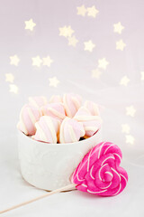 Candies and sweets on a white background. Lollipop heart and love. Sweets are harmful to teeth and dental treatment