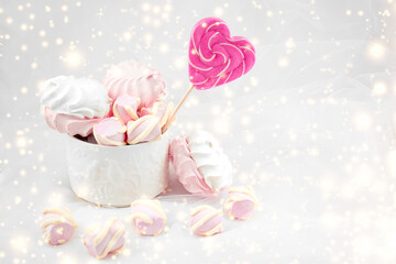 Candies and sweets on a white background. Lollipop heart and love. Sweets are harmful to teeth and dental treatment