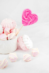 Candies and sweets on a white background. Lollipop heart and love. Sweets are harmful to teeth and dental treatment