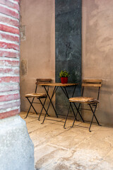 A small coffee table and two chairs in the streets of the El Born neighbohood in Barcelona in summer