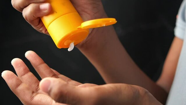  young men using sunscreen cream 