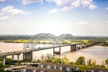 Beautiful shot of the design of Hernando de Soto Memphis bridge over a river and green landscape