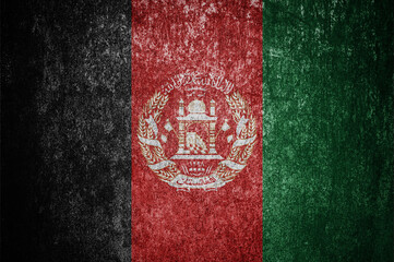 Closeup of grunge Afghan flag. Dirty Afghanistan flag on a metal surface