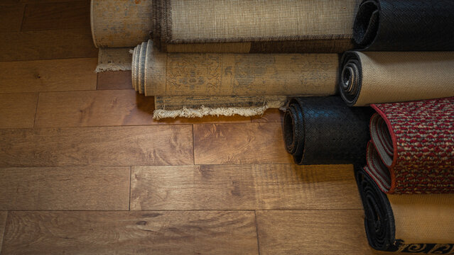 Interior background image of rolled-up carpets on the wooden floor