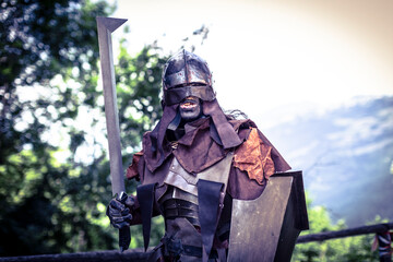 Uruk-hai warrior with helmet and sword from the lord of the rings - obrazy, fototapety, plakaty