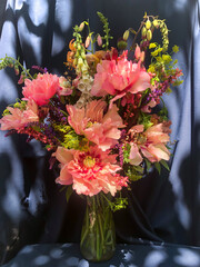 Romantic bouquets of spring flowers with peonies, sage, foxglove, geyhera