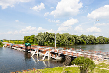 Bobrenevsky pedestrian movable pontoon bridge on Moskva River in Kolomna city on sunny summer day