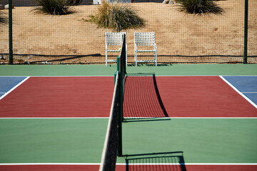 Pickelball court in desert with chairs