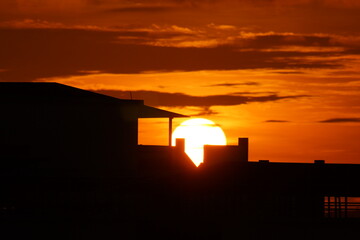 Fototapeta na wymiar Sunrise viewed through attap house