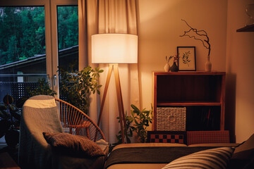 Lamp illuminating a decorative living room with warm light - obrazy, fototapety, plakaty