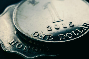 1 one Hong Kong dollar. Fragment of textured coin. Dark tinted illustration about economy or finance. Coins and money of Hong Kong. News about banks and currency. Budget and taxation. Macro