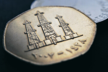 Translation: 2007. United Arab Emirates UAE coin close-up. 50 fils. Money illustration for news about economy or finance. Emirates loan and credit. Image of oil rigs. Macro