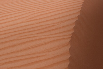 Horizontal close-up of the top of sand dunes in Al Wathba, a majestic desert in Abu Dhabi, United Arab Emirates.