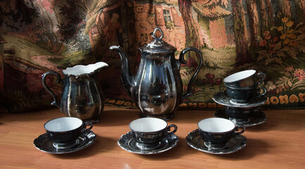 Vintage porcelain coffee set with silver painting