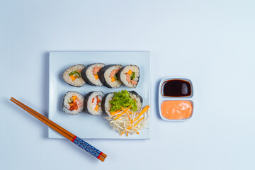 sushi rolls with chopsticks