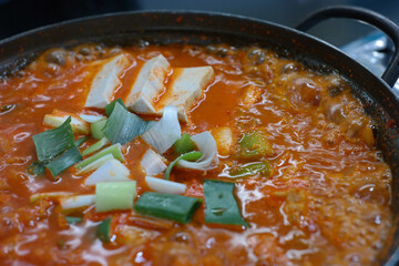 Over-fermented kimchi boiled with pork, bean curd, and green onion. Often considered Korean “soul food,” this spicy kimchi stew strikes a perfect balance with the greasy pork.
