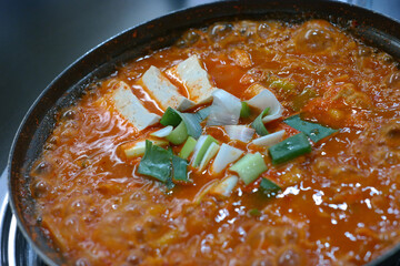 Over-fermented kimchi boiled with pork, bean curd, and green onion. Often considered Korean “soul food,” this spicy kimchi stew strikes a perfect balance with the greasy pork.