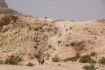 Wonderful mountain views with silhouettes of hiking people on the Jordan Trail from Little Petra...