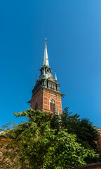 Fototapeta premium The spire of the bell tower with clocks of German church (Tyska kyrkan) in Stockholm, Sweden.