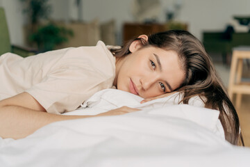 Obraz premium Portrait of a serene resting calm woman lying on a pillow.