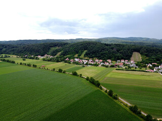 Fototapeta na wymiar Aerial view of an agricultural field with grain planted in spring in Bavaria