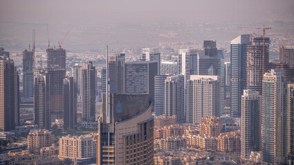 Fototapeta na wymiar Aerial view of tallest towers in Dubai Downtown skyline and highway timelapse.