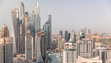 View of various skyscrapers in tallest recidential block in Dubai Marina aerial timelapse