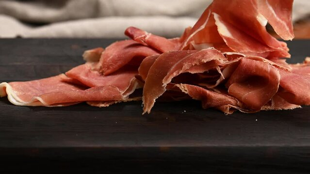 Sliced jamon on a wooden board, breakfast