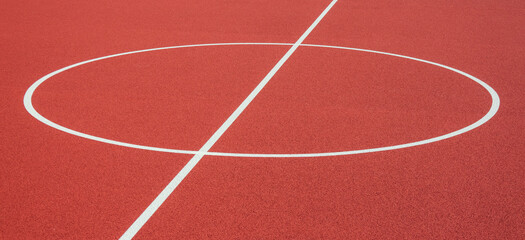 Sports court background. Top view to red artificial rubber ground with central circle field line...