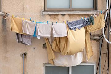 Bed linen and clothes are dried on a rope in the street in Israel