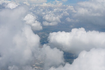 Obraz premium Altocumulus clouds are small mid-level layers or patches of clouds, called cloudlets, which most commonly exist in the shape of rounded clumps. Photos from the plane.