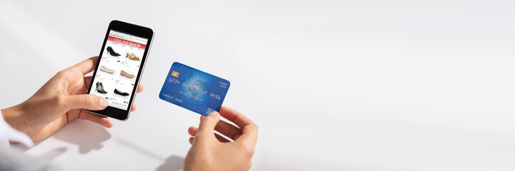 Woman Holding Credit Card In Hand Doing Online Shopping