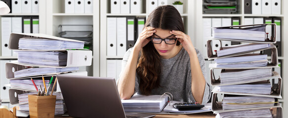 Worried Businesswoman Working At Office