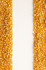portrait photo with popcorn kernels or seeds on both sides of the image and a space to write in the centre