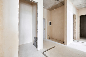 Interior of new apartment without finishing in gray tones