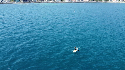 sea view and people doing padel board. drone shooting