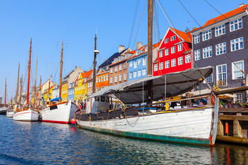 Fototapeta na wymiar Copenhagen Nyhavn with Boats . Colorful houses at water canal in Copenhagen Denmark