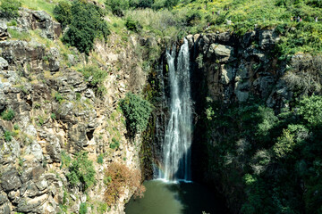 The second highest waterfall in Israel in the The waterfall Jalaboun on the shallow mountain Jalaboun stream with crystal clear water and shores overgrown with trees and grass