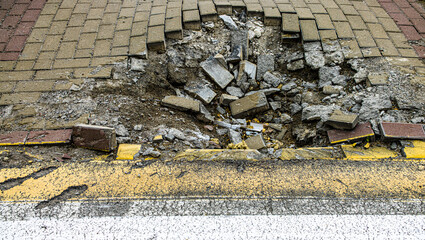 BUCHA, UKRAINE - June 20, 2022: crater funnel from a snard explosion at a crosswalk, sidewalk, asphalt