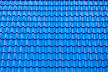 Architectural textured background of blue roof metal tile. Roof of a house with modern metal roof...