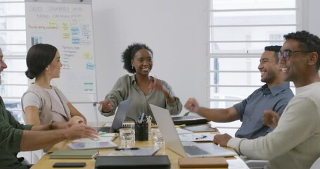 Colleagues joining hands in support and unity. Diverse group of businesspeople giving a high five in meeting in office. Passionate business professionals celebrating success and motivating each other